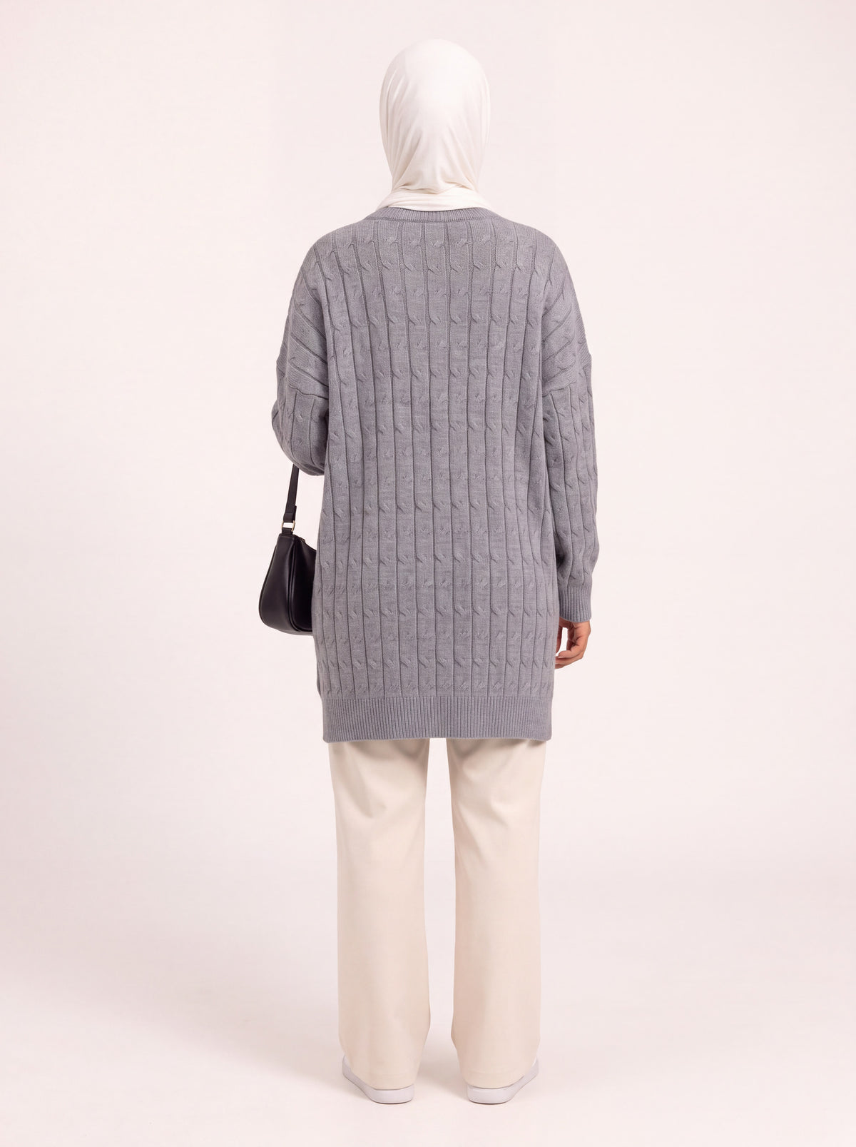 Pull long torsadé oversize gris porté de dos